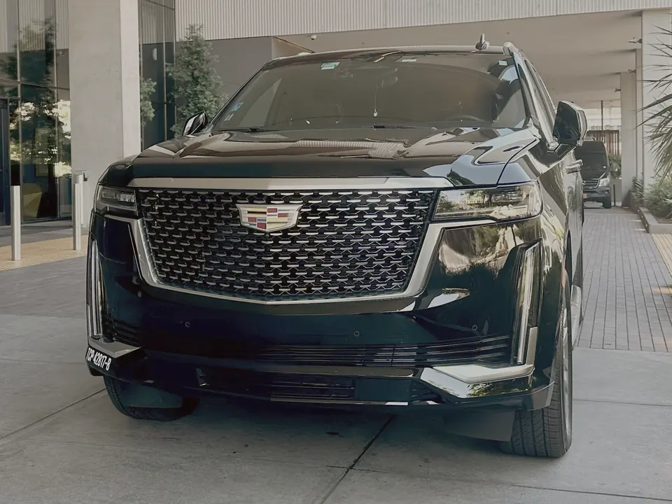 Cadillac Escalade beneath an entrance canopy